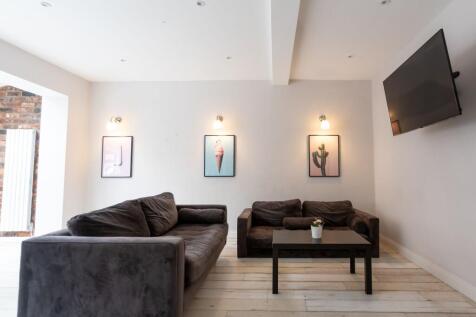 Bright, modern living area with two comfortable...