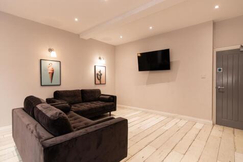 Contemporary living room with two plush dark so...