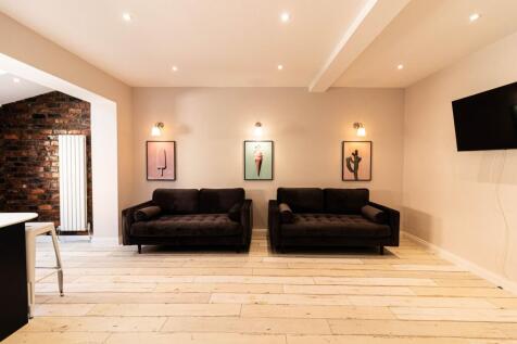 Contemporary living room with two matching dark...