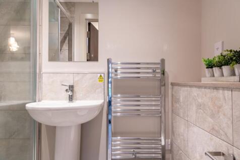 A modern bathroom featuring a clean white pedes...