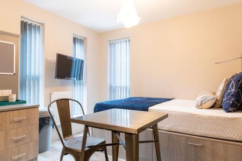 A bright and neatly organized single bedroom fe...