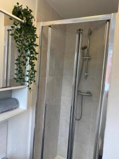 Contemporary tiled shower cubicle with chrome-f...