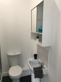 Bright, simply styled bathroom with a modern wh...