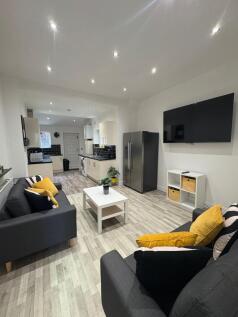 Bright, modern open-plan living area with match...