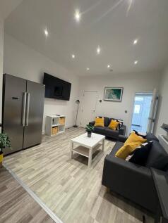 Modern open-plan living area with matching grey...