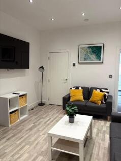 Bright, modern living room with neutral walls, ...