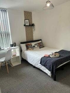 Bright, neatly styled bedroom with a double bed...