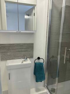 Contemporary bathroom with a tiled shower enclo...
