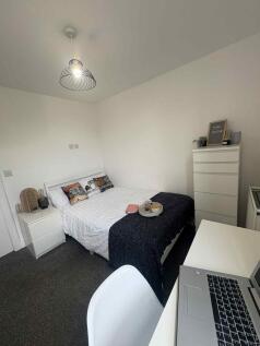 Bright, neatly styled double bedroom with a mad...