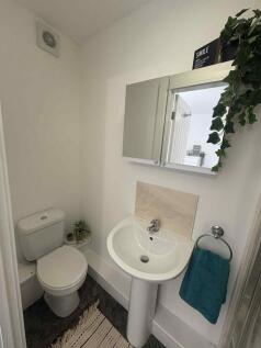 Bright, well-kept bathroom with a pedestal sink...