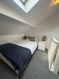 Cozy attic bedroom with a skylight, neat double...
