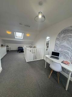 Bright, well-decorated loft bedroom with a stud...