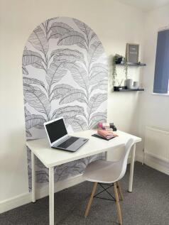 Bright, tidy study corner with a modern white d...