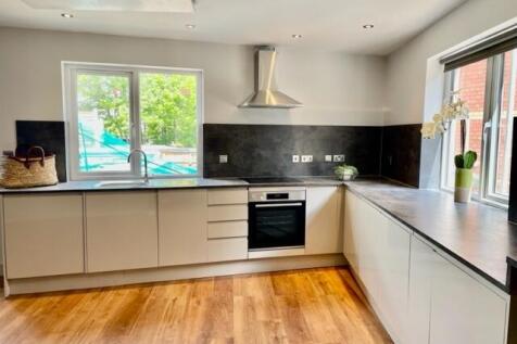 Bright modern kitchen with large windows, sleek...