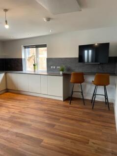 Bright modern kitchen with a long run of sleek ...
