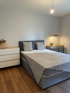 Bright, neutrally decorated double bedroom with...