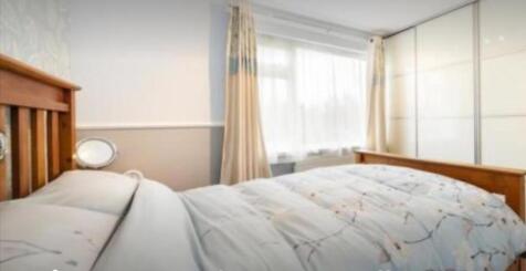 A bright and inviting double bedroom featuring ...