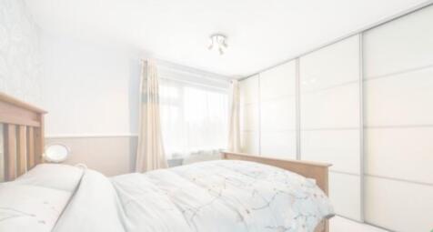 A bright and tidy double bedroom featuring ampl...