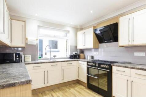 A clean and modern kitchen with ample space and...