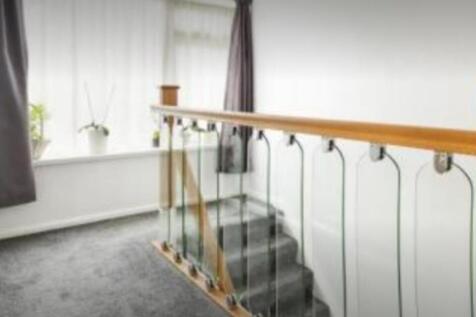 A bright and tidy hallway with elegant glass ra...