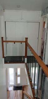 A bright and tidy hallway featuring stylish rai...