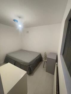 A simple, neatly arranged double bedroom featur...