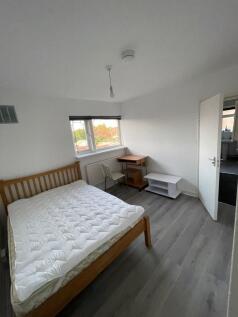 A neat and bright double bedroom featuring a wo...