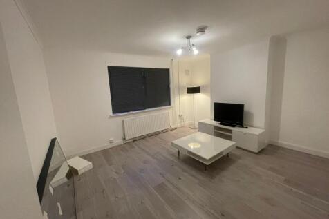 A modern, well-lit living room featuring a larg...