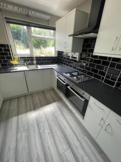 Bright and modern kitchen featuring sleek black...
