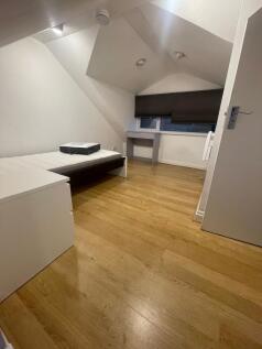 A cozy, well-maintained single bedroom with lig...