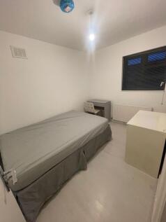 A neat and minimal single bedroom featuring a s...