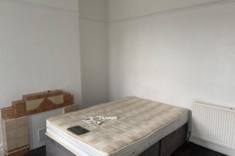 Bright, simply-fitted bedroom with a double div...