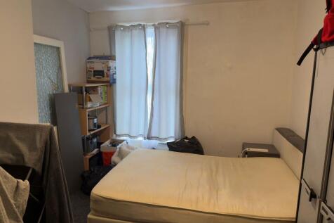 Bright bedroom with a large bed centered under ...