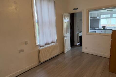 Bright ground-floor living area with wood-effec...