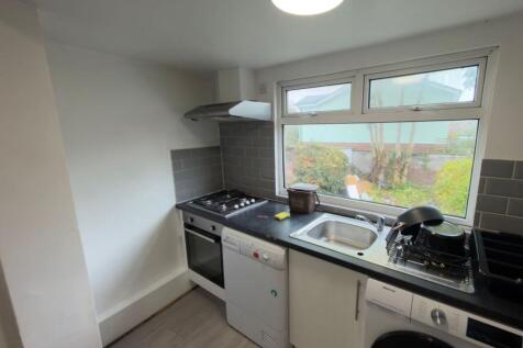 Bright modern kitchen with a large window over ...