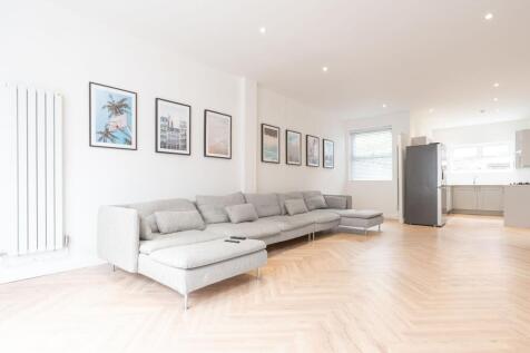 Bright, modern open-plan living area with a lon...