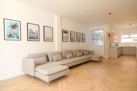 Spacious, modern open-plan living area with a l...