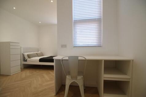 Bright, clean double bedroom with a simple whit...