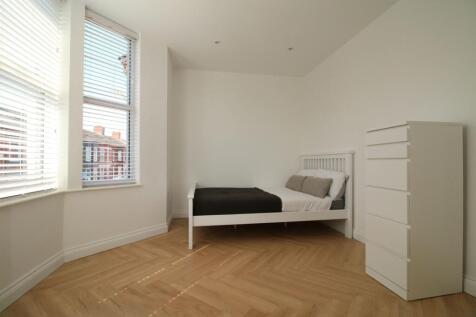 Bright, minimalist double bedroom with large ba...