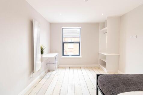 Bright, freshly redecorated bedroom with a larg...