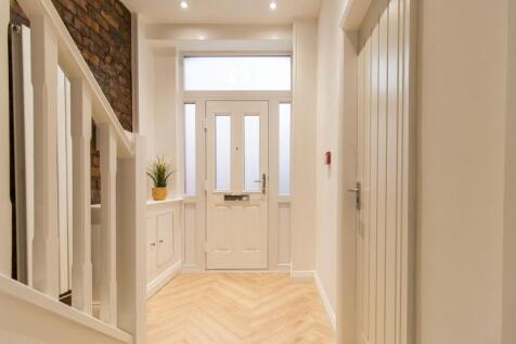 Bright, freshly painted entrance hallway with a...