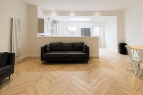 Bright, modern open-plan living area with light...