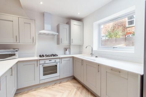 Bright, modern kitchen with neutral shaker-styl...