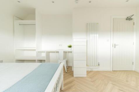 Bright, modern bedroom with clean white walls, ...