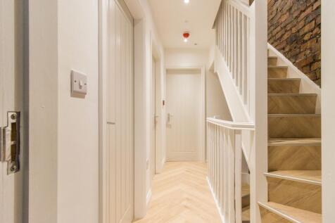 Bright, freshly renovated hallway with chevron ...