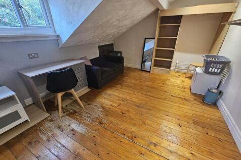 Bright attic-style double bedroom with polished...