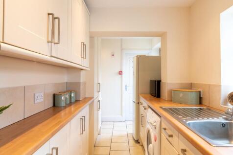 Bright, modern galley kitchen with wood-effect ...