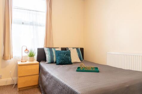 Bright, neatly presented bedroom with a comfort...