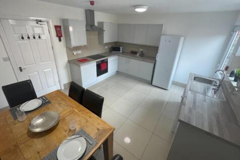 A spacious and well-lit kitchen featuring moder...
