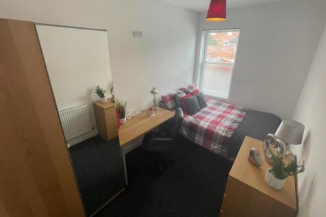 A bright and inviting double bedroom featuring ...